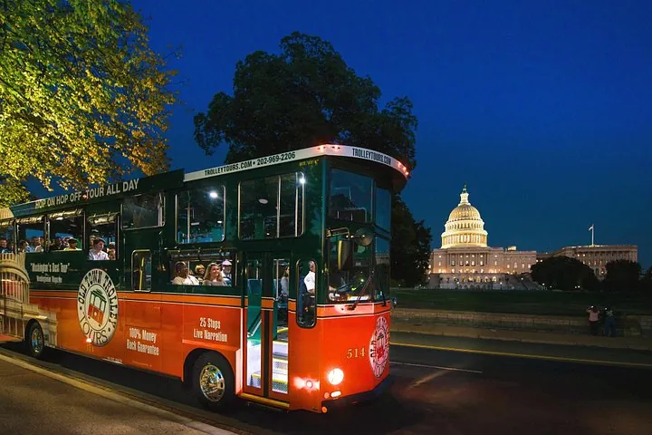 An open-air trolley stopped by the floodlit Lincoln Memorial at night on a Washington DC tour for seniors